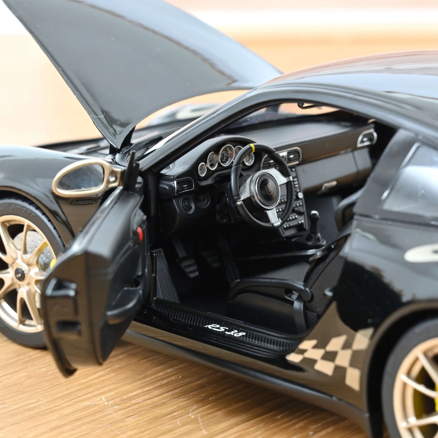 Porsche 911 GT3 RS 2009 black & gold - 1/18 Norev