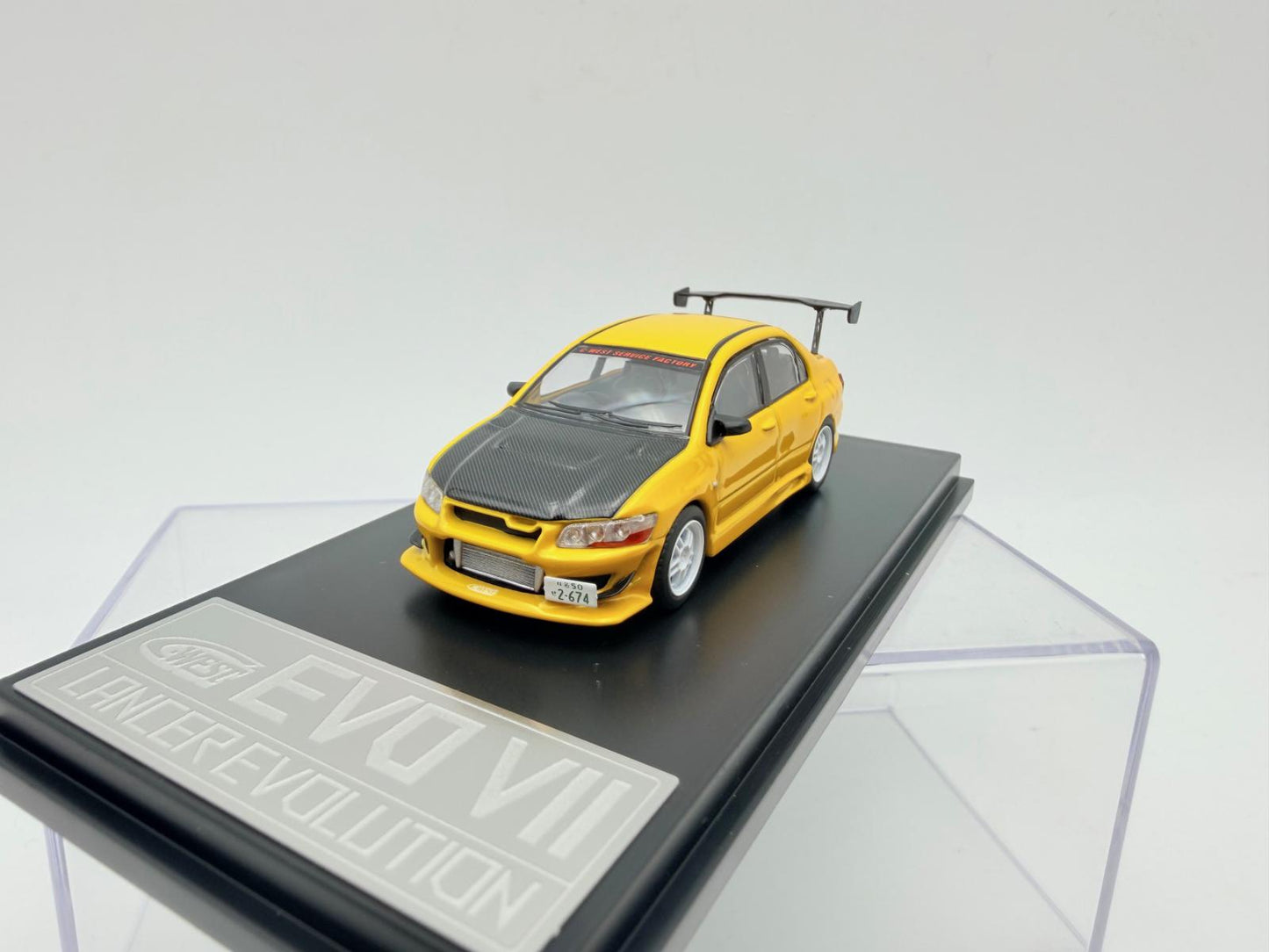 Mitsubishi Lancer EVO VII galben  cu vitrina plexiglass - 1/64 Fast & Speed